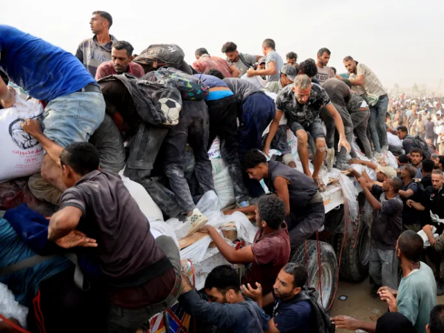 Palestinians scramble to collect aid supplies from trucks in Khan Younis [Reuters]