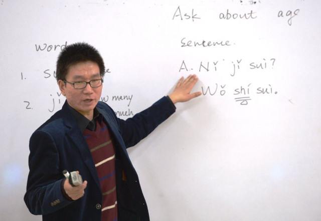 schoolchildren learn chinese from their teacher haiwei in the city school in islamabad photo afp schoolchildren learn chinese from their teacher haiwei in the city school in islamabad photo afp