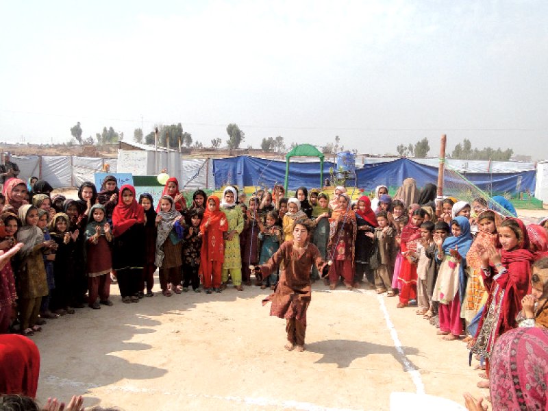 a girl performs tricks at an event to mark the day at jalozai camp photo express