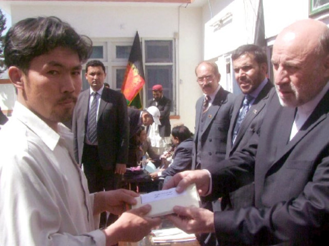 afghan ambassador to pakistan mohammad omer dawoodzai hands over a cheque to a family member of hazara town blast victim photo inp afghan ambassador to pakistan mohammad omer dawoodzai hands over a cheque to a family member of hazara town blast victim photo inp