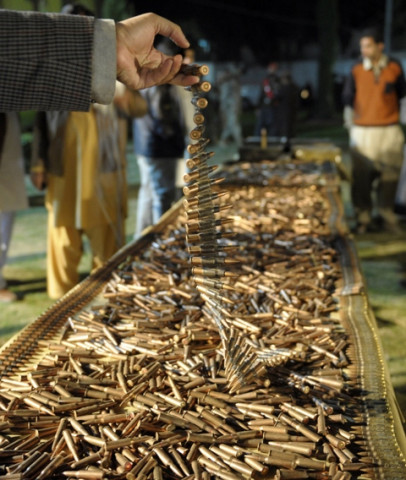 a pakistani security personell examines bullets displayed at a security compound in quetta late march 8 2013 photo afp