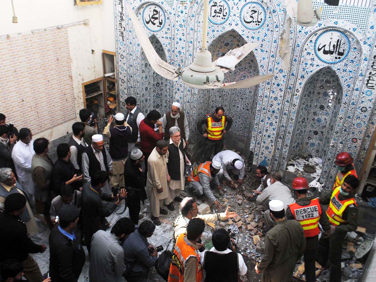 investigators inspect the site of explosion inside a mosque in peshawar on march 9 2013 photo muhammad iqbal express