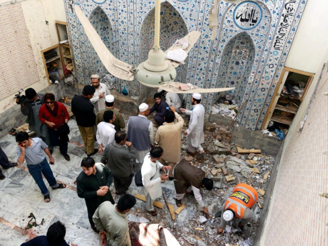 police officials residents and volunteers inspecting the blast site in a mosque in peshawar photo afp police officials residents and volunteers inspecting the blast site in a mosque in peshawar photo afp