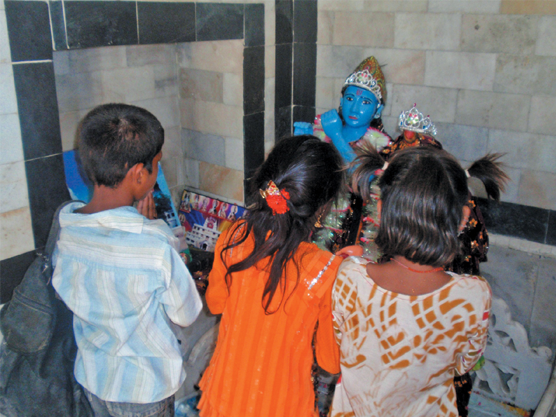 children pray inside the sadh bello temple in sukkur in celebration of the shiv ratri festival on sunday photo express