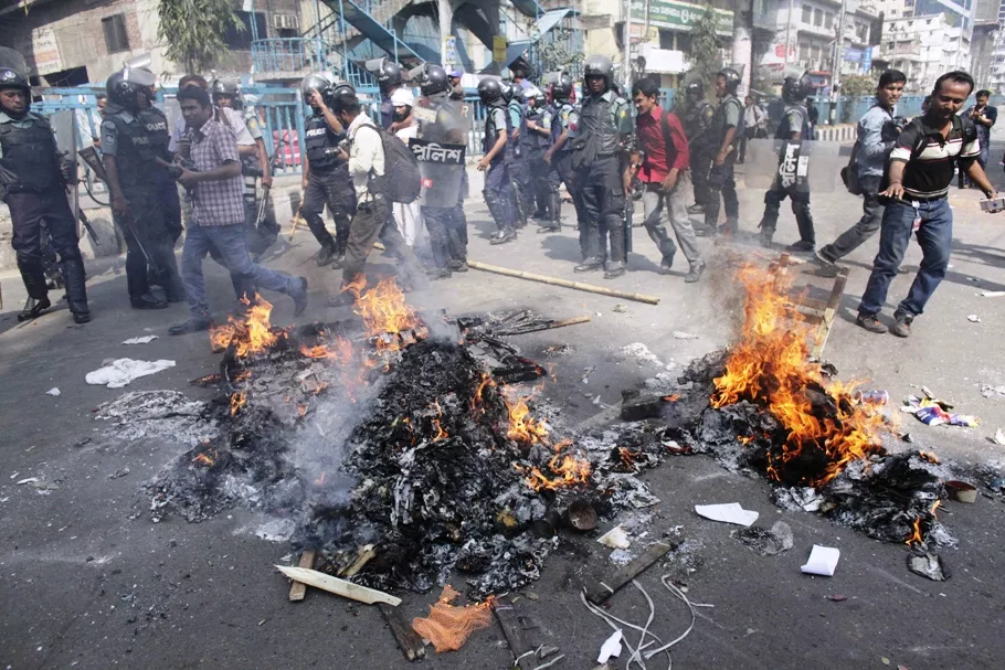 police walk past piles of paper set alight by activists from 12 parties in front of the national mosque in dhaka february 22 2013 photo reuters police walk past piles of paper set alight by activists from 12 parties in front of the national mosque in dhaka february 22 2013 photo reuters