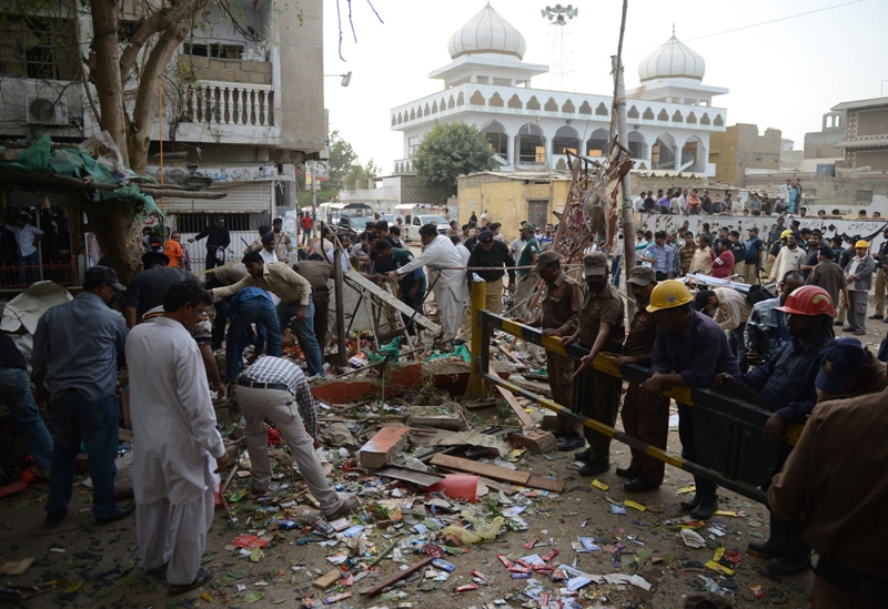 pakistani security officials examine the site of an explosion in karachi on march 11 2013 photo afp