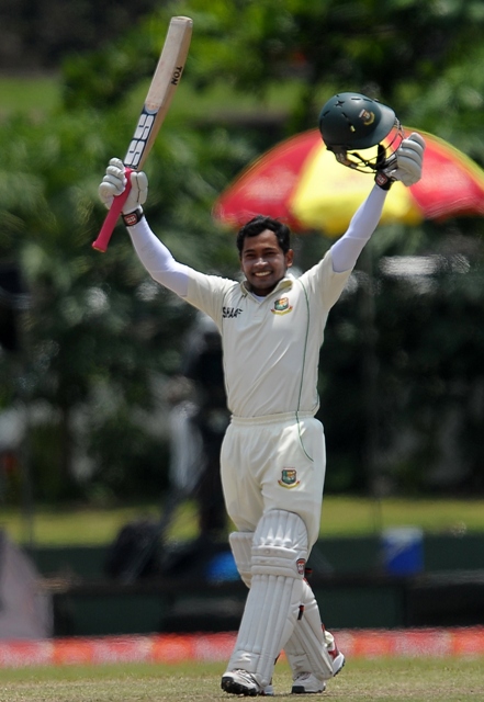 bangladeshi captain mushfiqur rahim raises his bat and helmet in celebration after scoring a double century 200 runs during the fourth day of the opening test match between sri lanka and bangladesh at the galle international cricket stadium in galle on march 11 2013 photo afp lakruwan wanniarachchi