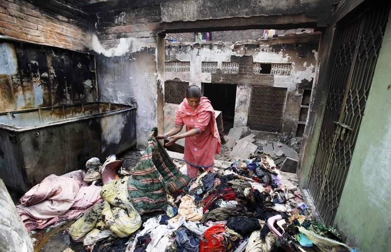 shumaila 48 looks through her family belongings at a section of her home after it was burnt by a mob two days earlier in badami bagh photo reuters