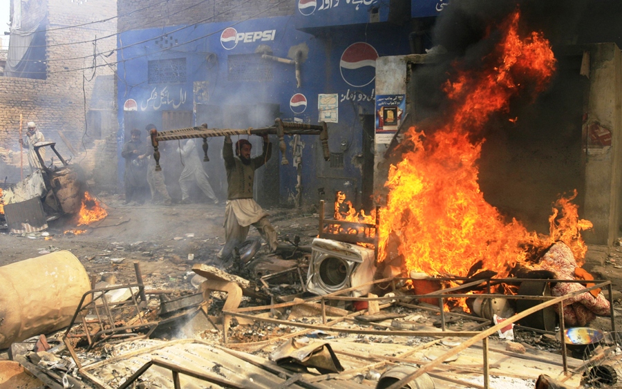 an angry demonstrator burns furniture during a protest in the badami bagh area of lahore march 9 2013 photo reuters