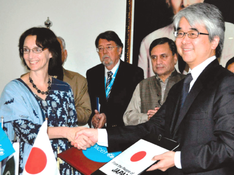 officials exchange files at the ceremony photo zafar aslam express