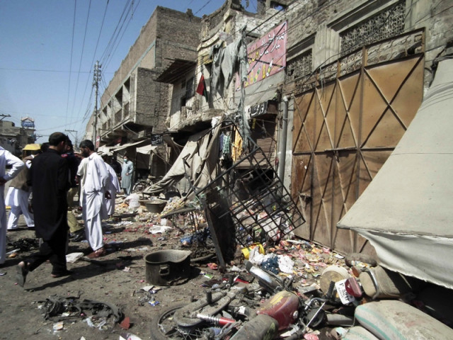 security officials gather at the site of a bomb attack near a police station in bannu march 12 2013 photo reuters security officials gather at the site of a bomb attack near a police station in bannu march 12 2013 photo reuters