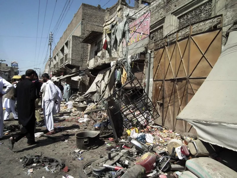 security officials gather at the site of a bomb attack near a police station in bannu march 12 2013 photo reuters