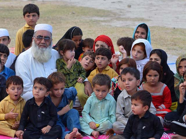 gulzar khan who fled with his family following a military operation against militants in the north waziristan tribal agency pictured with some of his children in bannu photo afp