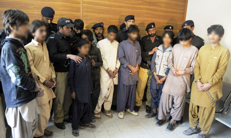 pakistani police produce young children suspected of planting bombs to the media in quetta on march 13 2013 photo afp