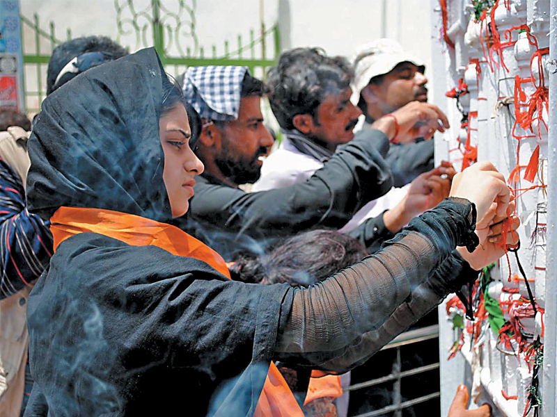 this file photo shows people paying their respects at the shrine of hazrat lal shahbaz qalandar in sehwan