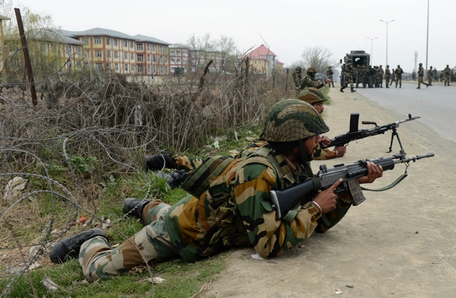 indian soldiers take positions outside a school after an attack against indian paramilitary personnel in srinagar on march 13 2013 photo afp