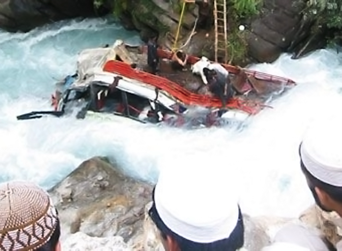 residents look as rescuers try to pull out the buss from the river photo izhar ali