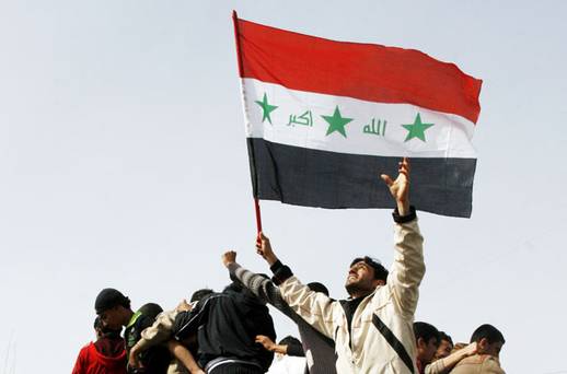 protesters carrying the iraqi flag climb on a military vehicle during a demonstration in mosul photo reuters file