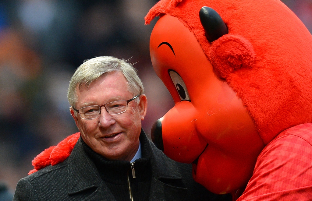 manchester united manager alex ferguson l is hugged by mascot fred the red as he makes his way to the bench before the english premier league football match between manchester united and reading at old trafford in manchester north west england on march 16 2013 photo afp