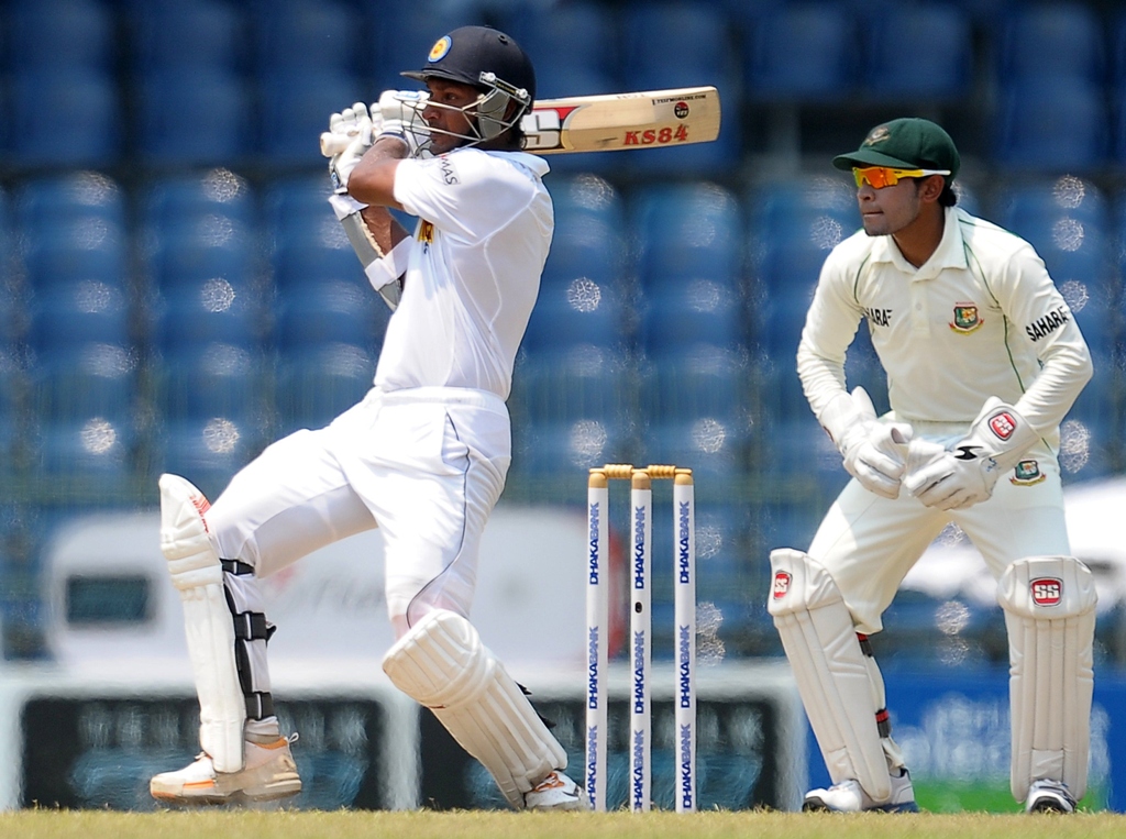 sri lanka 039 s cricketer kumar sangakkara l plays a shot as bangladeshi wicketkeeper and captain mushfiqur rahim r look on during the second day of their second test match between sri lanka and bangladesh at the r premadasa cricket stadium in colombo on march 17 2013 photo afp