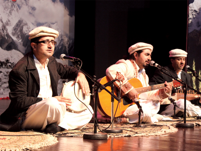 afghan artists ustad ghulam hussain and ustad faqeer hussain with pashto singer zarsanga top sada e pamir from gojal left and a musical band from hunza right showcase their musical talents photo waqas naeem express