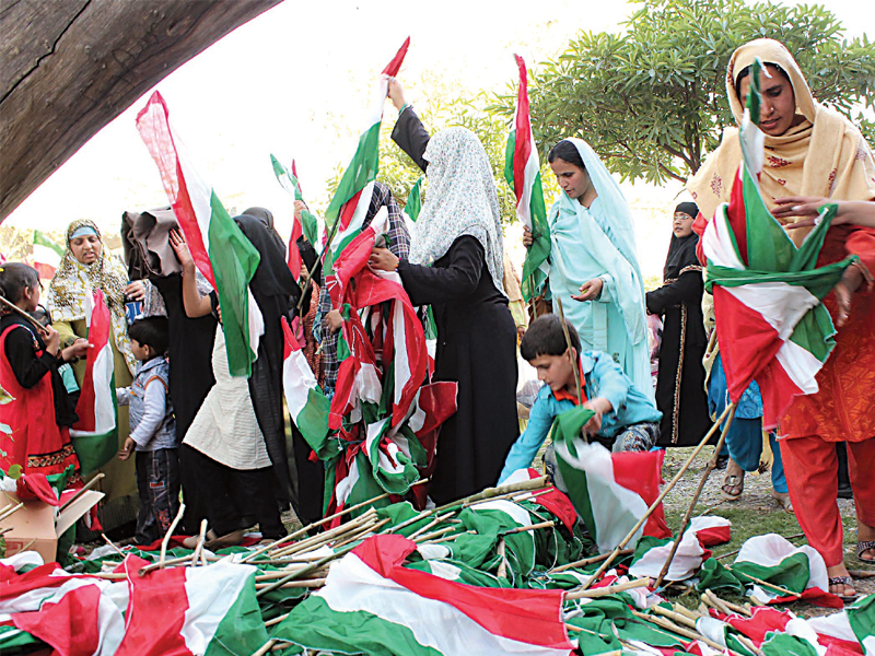 women and children distribute party flags to fellow supporters photo mohammad javaid