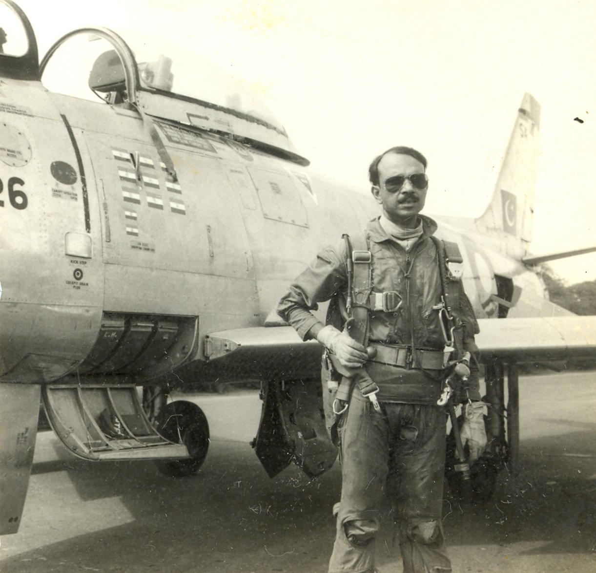 this undated photograph released by the pakistan air force shows mm alam standing next to his f 86 sabre photo paf