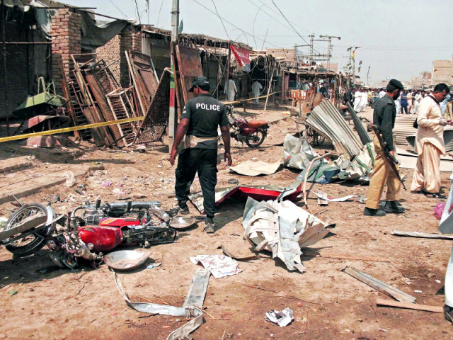 policemen inspect the devastation of the bomb blast in dera allah yar photo afp policemen inspect the devastation of the bomb blast in dera allah yar photo afp