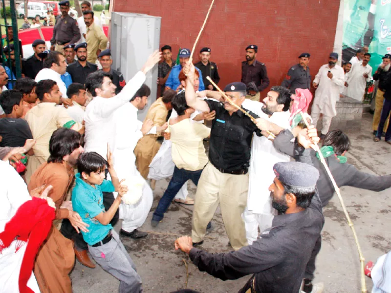 police baton charge crowd at the main gate photo abid nawaz shafiq malik express police baton charge crowd at the main gate photo abid nawaz shafiq malik express
