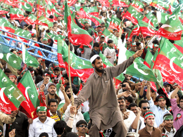 pti supporters wave party flags during the naya pakistan rally at minar e pakistan photo shafiq malik express pti supporters wave party flags during the naya pakistan rally at minar e pakistan photo shafiq malik express