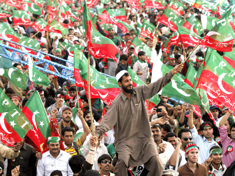 pti supporters wave party flags during the naya pakistan rally at minar e pakistan photo shafiq malik express