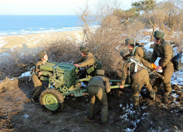 north korean female artilleries moving a rocket launcher during the landing and anti landing drills on march 25 2013 photo afp north korean female artilleries moving a rocket launcher during the landing and anti landing drills on march 25 2013 photo afp