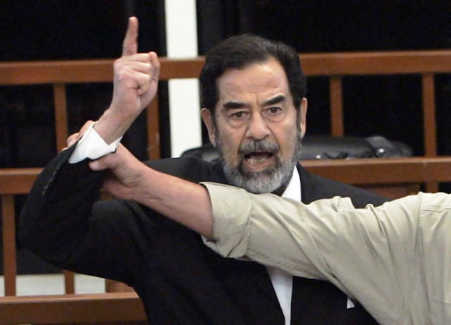 a november 5 2006 file photo of former iraqi president saddam hussein shouting at the court as a bailiff attempts to silence him during the delivery of his verdict in his trial photo afp