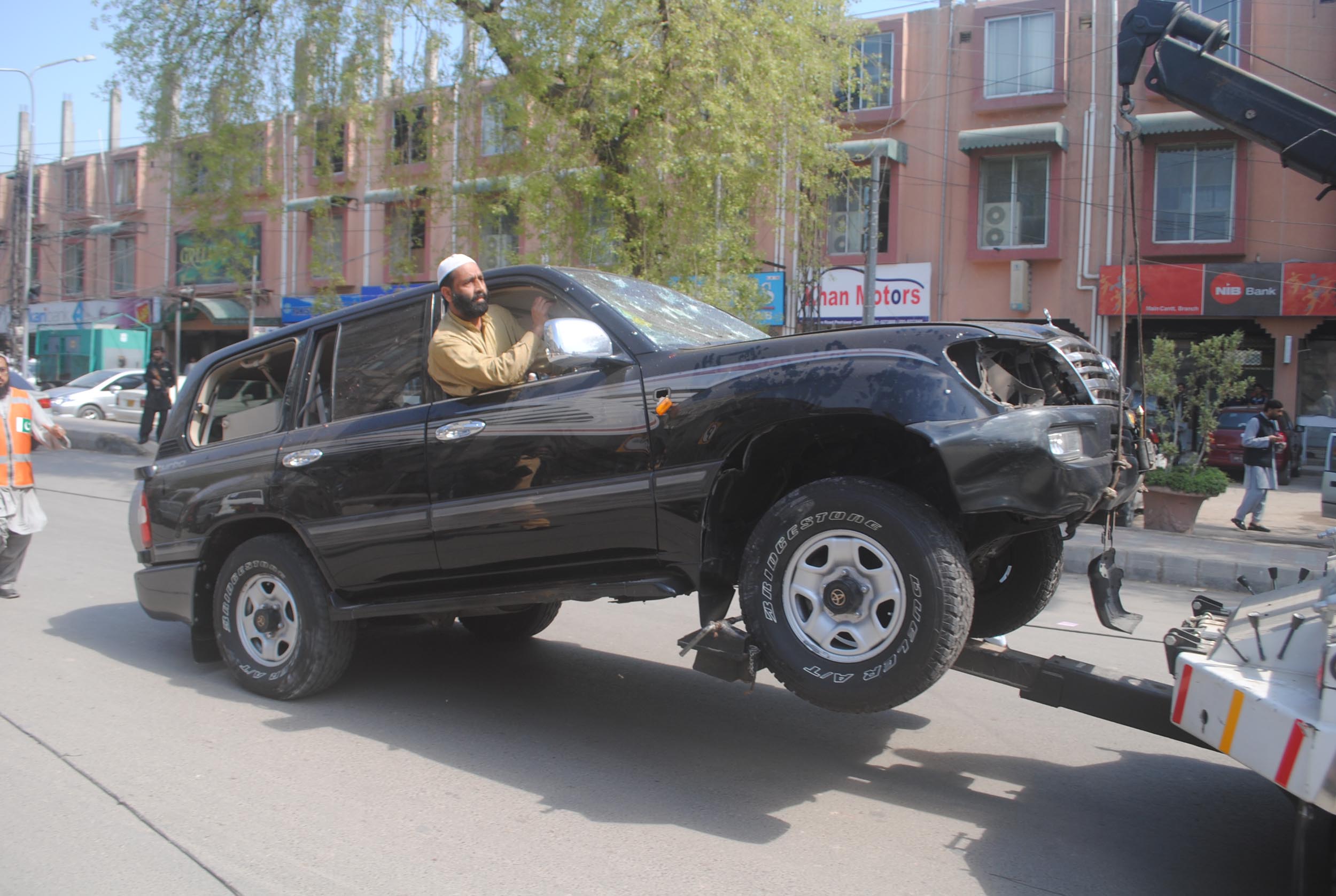 an suv damaged in the blast is towed away photo mohammad iqbal express