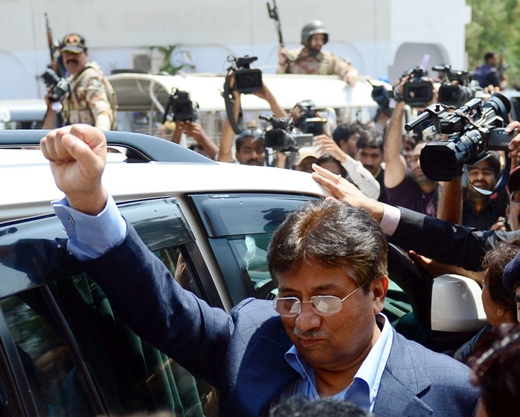 former president pervez musharraf makes a fist after appearing at the sindh high court in karachi on march 29 2013 photo afp