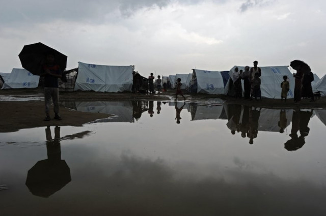 this file picture taken on october 11 2012 shows muslim rohingyas reflected in a puddle following heavy monsoon rains at the say thamagyi internally displaced persons idp camp located on the outskirts of sittwe capital of myanmar 039 s western rakhine state photo afp this file picture taken on october 11 2012 shows muslim rohingyas reflected in a puddle following heavy monsoon rains at the say thamagyi internally displaced persons idp camp located on the outskirts of sittwe capital of myanmar 039 s western rakhine state photo afp