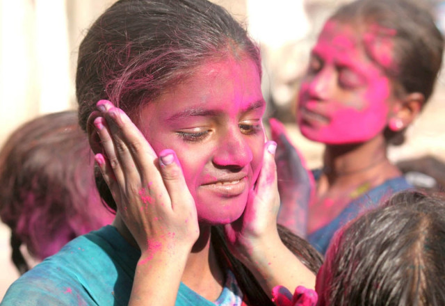a girl is seen celebrating the hindu festival of holi in a city of pakistan photo athar khan a girl is seen celebrating the hindu festival of holi in a city of pakistan photo athar khan