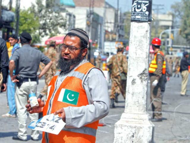 a rescue worker holds the milk bottle of an infant killed in the blast in peshawar photo reuters a rescue worker holds the milk bottle of an infant killed in the blast in peshawar photo reuters