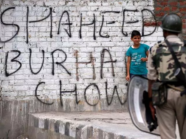 a boy stands next to a wall painted with graffiti during a protest in srinagar photo reuters a boy stands next to a wall painted with graffiti during a protest in srinagar photo reuters