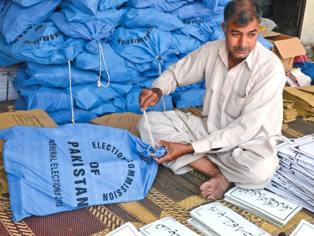 an ecp worker packs documents for polling stations in lahore photo afp an ecp worker packs documents for polling stations in lahore photo afp