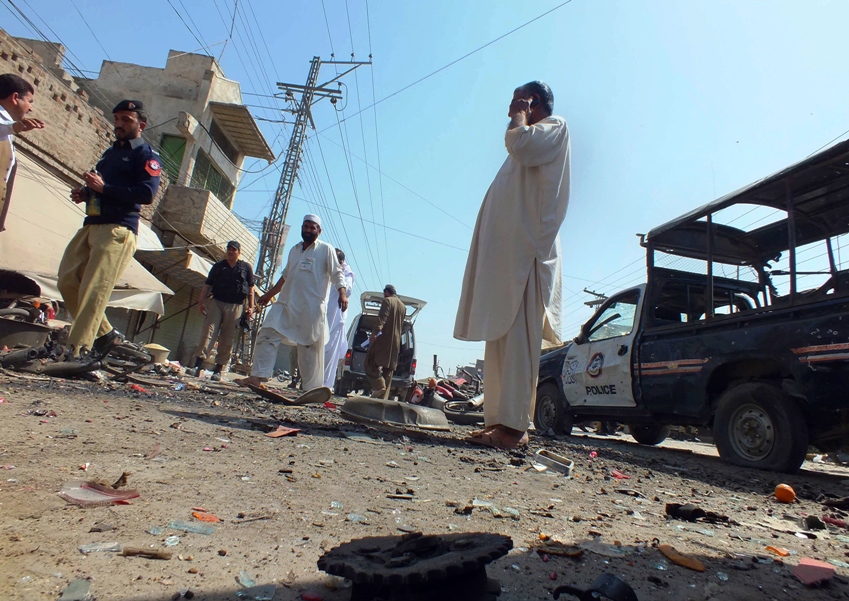 security officials examine the site of a bomb explosion in the town of bannu on march 12 2013 photo afp