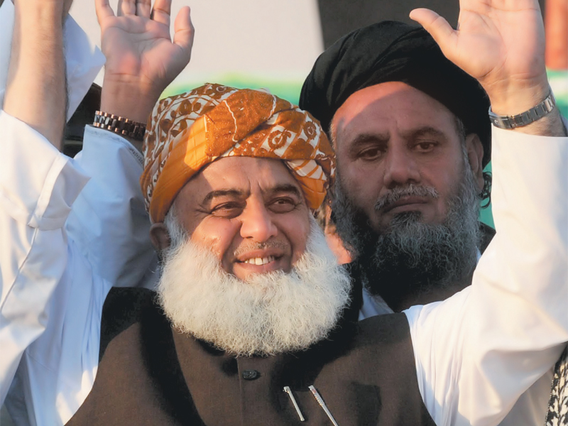 jui f leader fazlur rehman gestures as he arrives to address an election rally in lahore photo afp