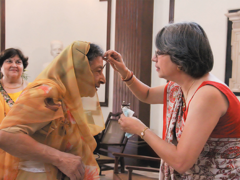 the principal of the school furengeez tampal puts a tilak on dr bn mama the chairperson of the school s management committee photo ayesha mir express