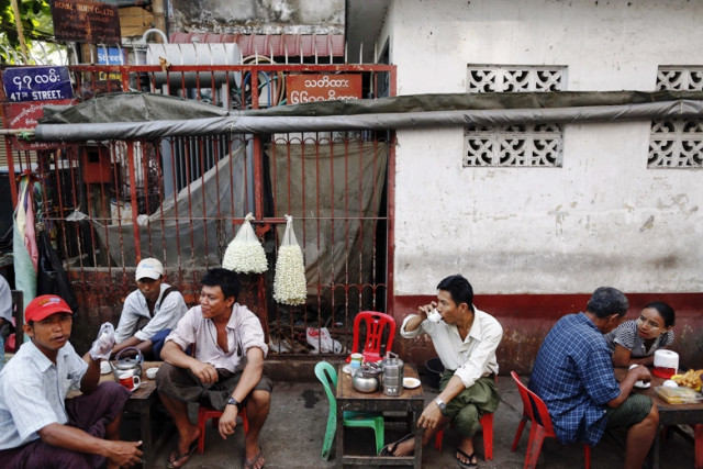 people sit at a tea shop near an islamic school where 13 boys were killed after a fire on tuesday in the central multi ethnic botataung district of the former capital yangon april 3 2013 photo reuters people sit at a tea shop near an islamic school where 13 boys were killed after a fire on tuesday in the central multi ethnic botataung district of the former capital yangon april 3 2013 photo reuters