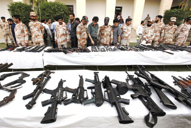 pakistani rangers and journalists stand beside a display of confiscated weapons during a media briefing photo reuters file pakistani rangers and journalists stand beside a display of confiscated weapons during a media briefing photo reuters file