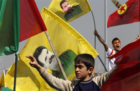 demonstrators hold kurdish flags and flags with portraits of jailed kurdistan workers party pkk leader abdullah ocalan during a gathering to celebrate newroz in the southeastern turkish city of diyarbakir march 21 2013 photo reuters