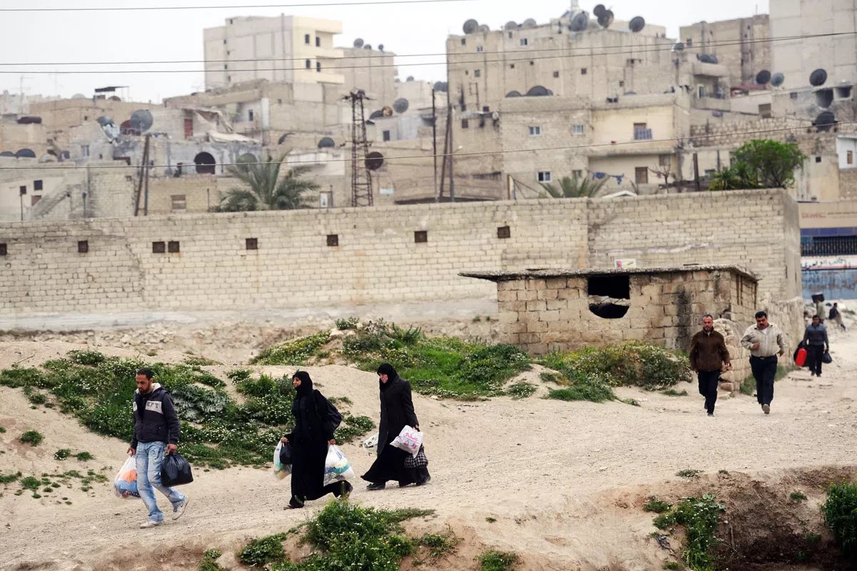 syrians carry their belongings as they leave sheikh maqsud neighborhood in aleppo on april 4 2013 photo afp syrians carry their belongings as they leave sheikh maqsud neighborhood in aleppo on april 4 2013 photo afp