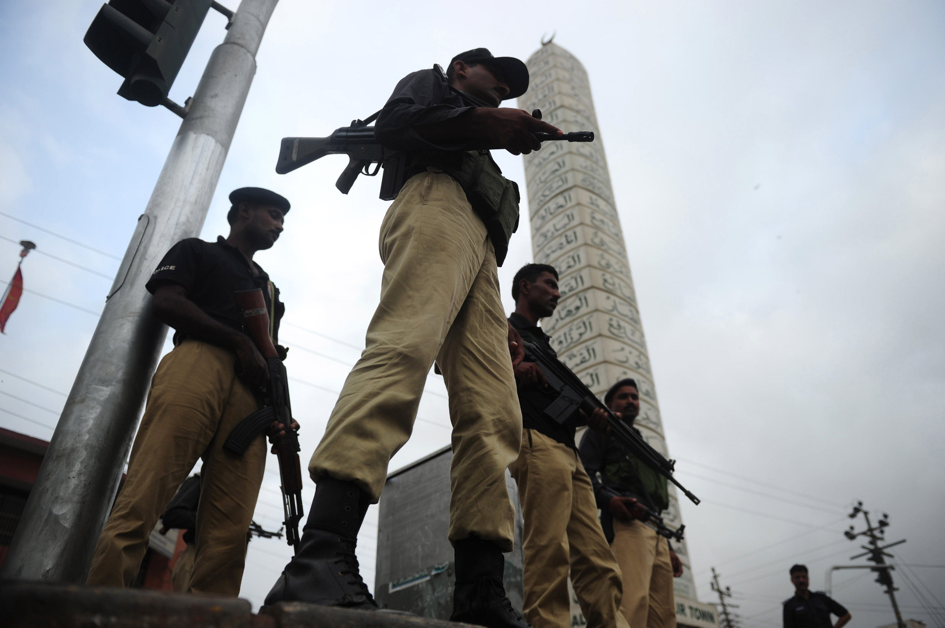 pakistani policemen stand guard in a troubled neighbourhood in karachi photo afp file