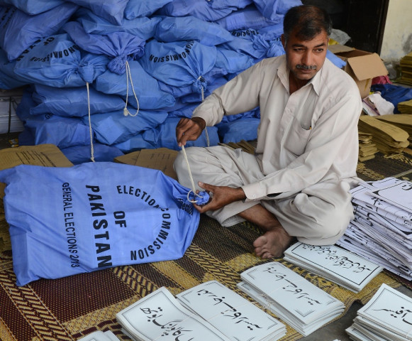 an election commission worker packs documents for polling stations in their bags for general election in lahore on march 30 2013 photo afp file an election commission worker packs documents for polling stations in their bags for general election in lahore on march 30 2013 photo afp file