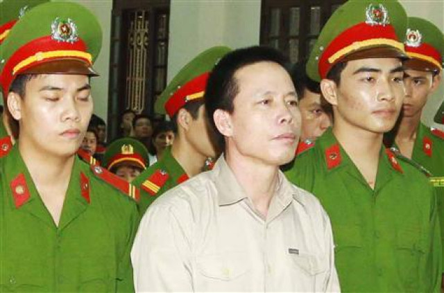 doan van vuon c stands with policemen in front of the dock at a court during a verdict session in hai phong photo reuters doan van vuon c stands with policemen in front of the dock at a court during a verdict session in hai phong photo reuters